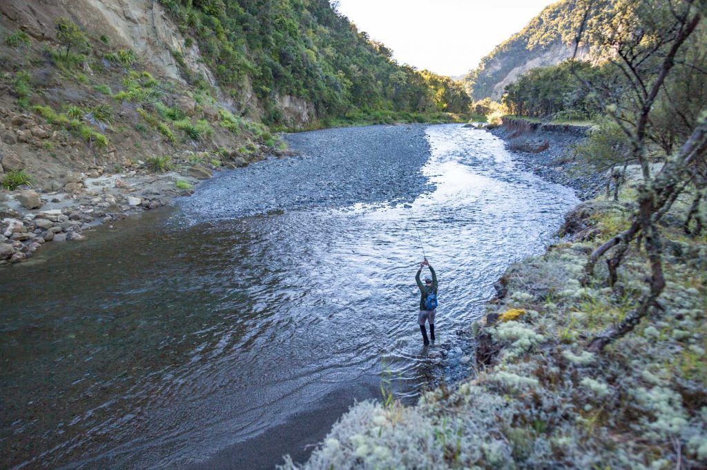 fly fishing backing fish running down mountain stream
